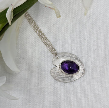 Textured heart shaped ecosilver pendant set with an oval amethyst