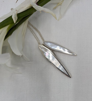 Two slices of mother of pearl set in silver pointed leaf pendant