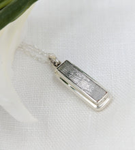 Load image into Gallery viewer, Long rectangular meteorite slice set in a double bezel silver setting as a pendant
