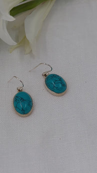 Marbled turquoise ovals set in silver dangle and drop earrings