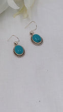 Load and play video in Gallery viewer, Bright turquoise ovals set in silver ornate dangle and drop earrings
