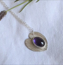 Load and play video in Gallery viewer, Textured heart shaped ecosilver pendant set with an oval amethyst
