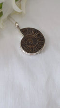 Load and play video in Gallery viewer, ammonite fossil pendant set in double bezelled solid silver backed setting
