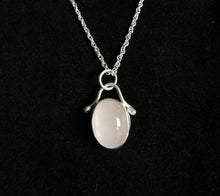 Load image into Gallery viewer, Polished oval rose quartz pendant with silver embellishment hanging on a silver rope chain
