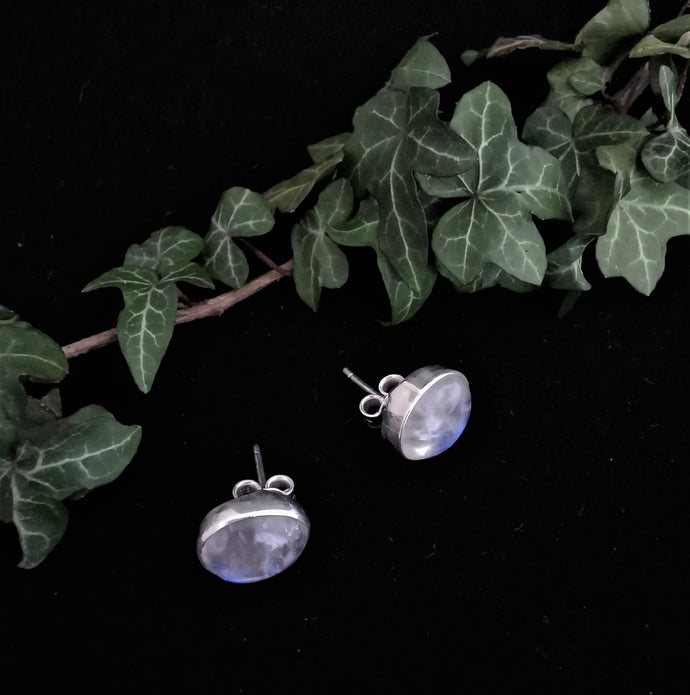 White polished moonstone ovals set in silver oval earrings with stud backs