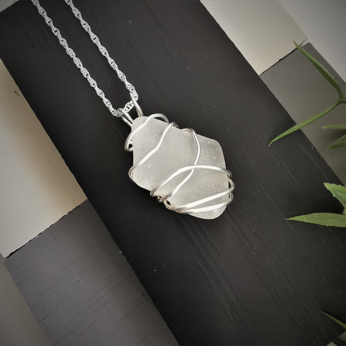 White seaglass pendant wrapped in silver wire