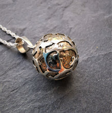 Load image into Gallery viewer, Small brass sphere pendant with intricate silver decoration
