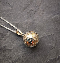 Load image into Gallery viewer, Small brass sphere pendant with intricate silver decoration

