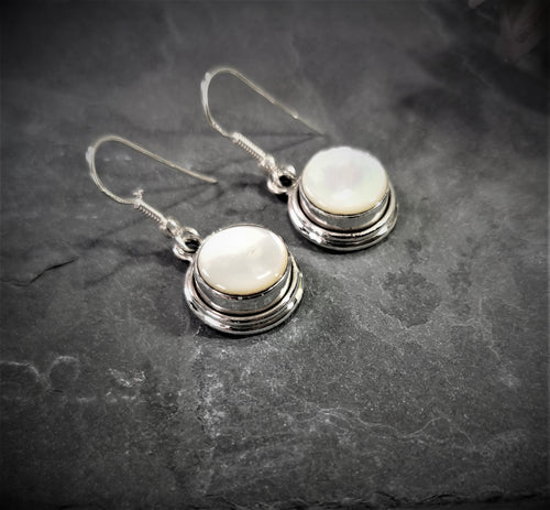 Mother of pearl round dangle and drop earrings set in silver double bezel