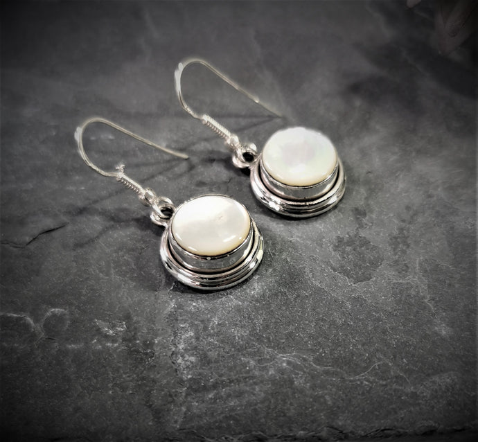 Mother of pearl round dangle and drop earrings set in silver double bezel