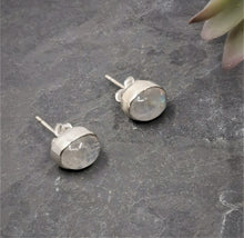 Load image into Gallery viewer, White polished moonstone ovals set in silver oval earrings with stud backs
