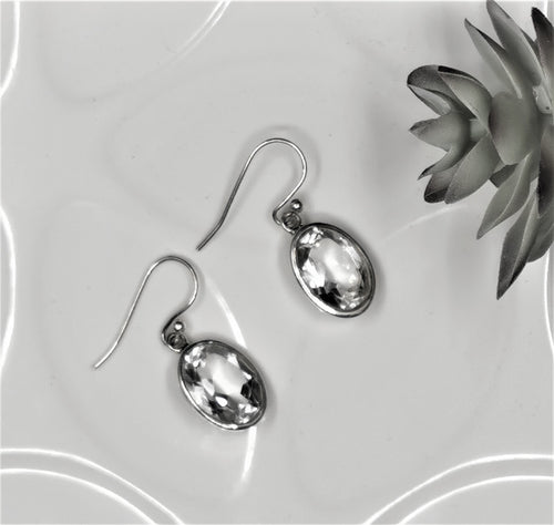 Faceted clear quartz crystal ovals set in solid silver as drop earrings 