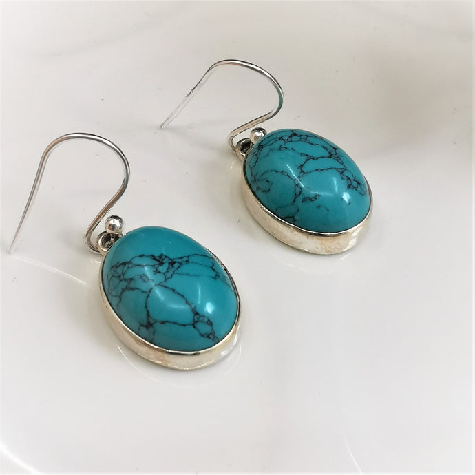 Marbled turquoise ovals set in silver dangle and drop earrings