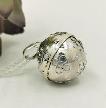 Load image into Gallery viewer, Silver sphere with silver flower detail on a silver chain
